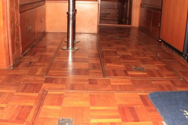 Slide: The Image of 1977 CHB Double Cabin interior with wooden parquet flooring and metal pole. - 33
