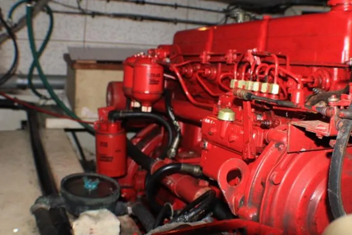 Slide: The Image of Red engine inside a 1977 CHB Double Cabin boat, showcasing mechanical components. - 35