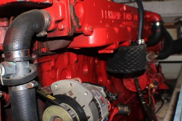 Slide: The Image of Red engine of a 1977 CHB Double Cabin boat, showcasing mechanical components. - 37