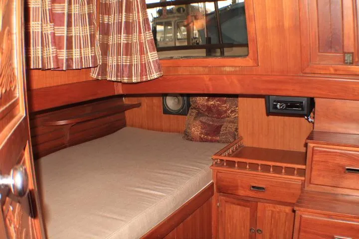 Slide: The Image of 1977 CHB Double Cabin interior with wooden furnishings and cozy bed. - 44