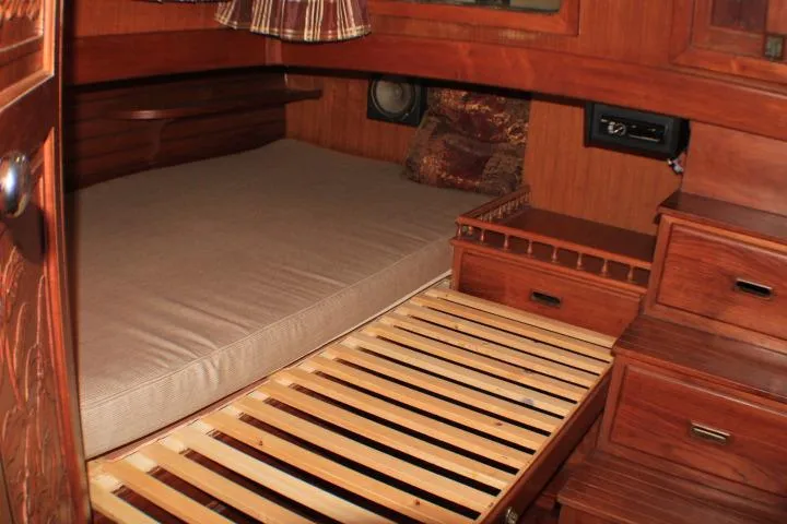 Slide: The Image of 1977 CHB Double Cabin interior with wooden furnishings and bed. - 45