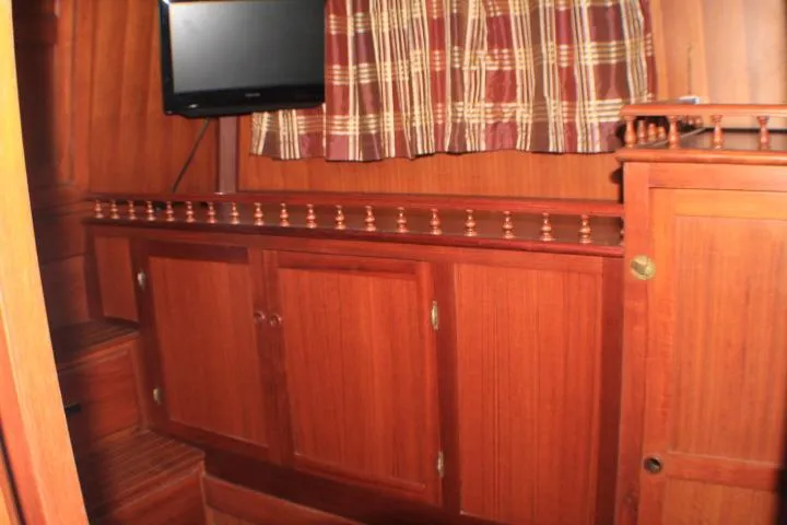 Slide: The Image of 1977 CHB Double Cabin interior with wooden cabinetry and mounted TV. - 46