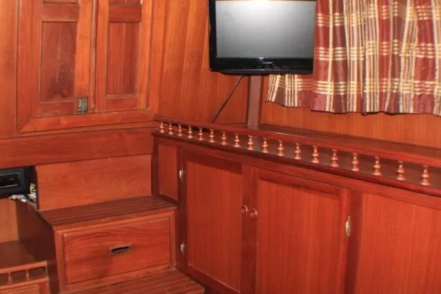 Slide: The Image of 1977 CHB Double Cabin interior with wooden cabinetry and mounted TV. - 47