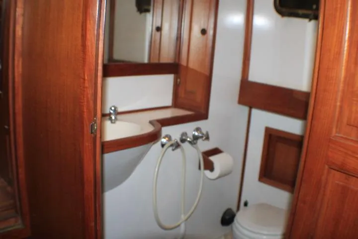 Slide: The Image of 1977 CHB Double Cabin bathroom with wooden cabinetry and white fixtures. - 49