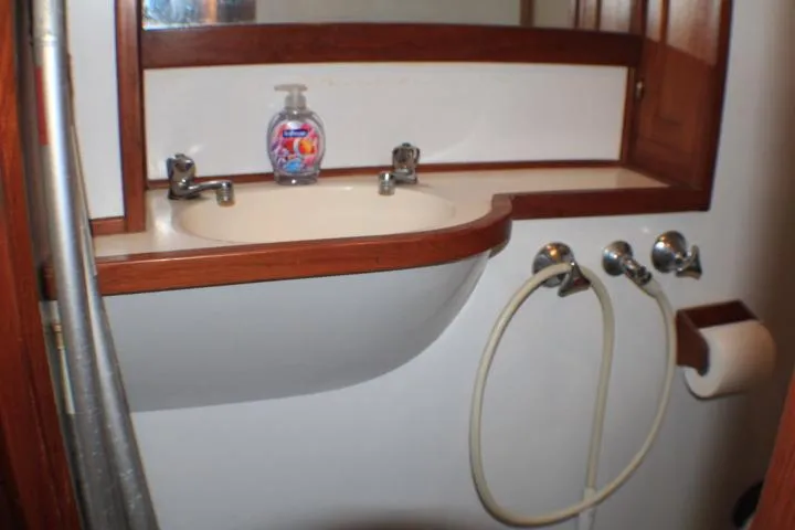 Slide: The Image of 1977 CHB Double Cabin bathroom with sink, mirror, and soap dispenser. - 50