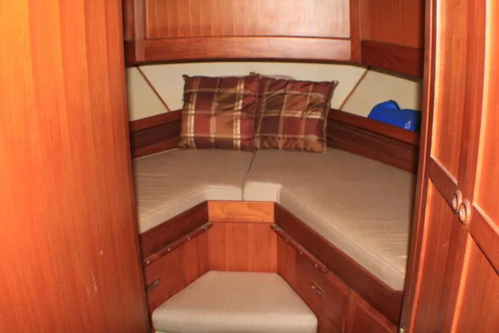 Slide: The Image of 1977 CHB Double Cabin interior with cozy V-berth and plaid pillows. - 52