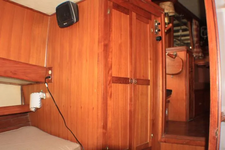 Slide: The Image of 1977 CHB Double Cabin interior with wooden paneling and built-in storage. - 53