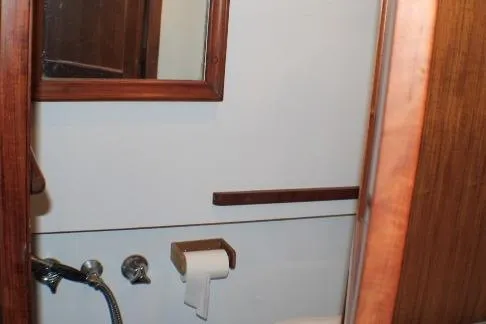 Slide: The Image of 1977 CHB Double Cabin bathroom with wooden accents and mirror. - 56