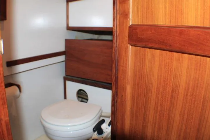Slide: The Image of 1977 CHB Double Cabin bathroom with wooden cabinetry and white fixtures. - 57