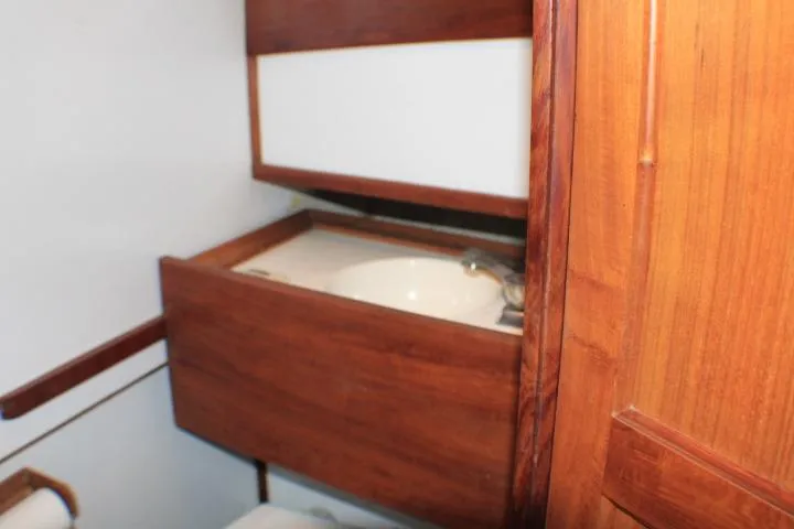 Slide: The Image of 1977 CHB Double Cabin bathroom with wooden cabinetry and sink. - 58