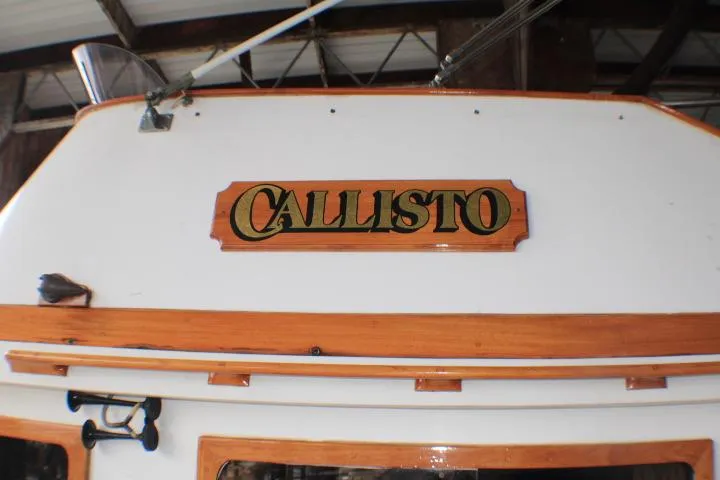 Slide: The Image of 1977 CHB Double Cabin boat with "Callisto" nameplate, wooden trim, and nautical details. - 7