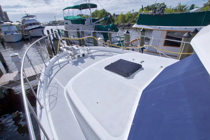 Slide: The Image of 1984 Present Yachts 42 Sundeck docked, showcasing spacious deck and marina view. - 10