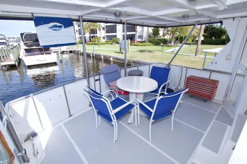 Slide: The Image of 1984 Present Yachts 42 Sundeck with outdoor seating, docked at marina. - 12