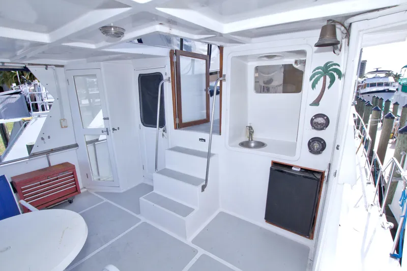 Slide: The Image of 1984 Present Yachts 42 Sundeck interior with sink, stairs, and nautical decor. - 13