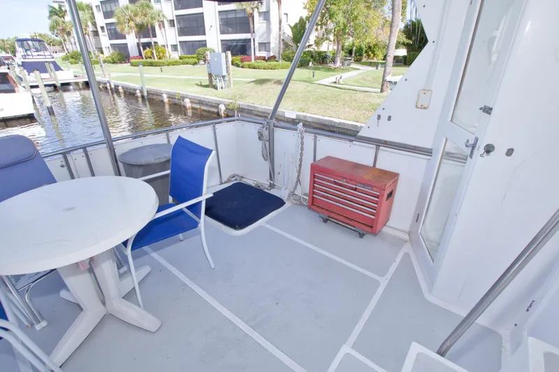 Slide: The Image of 1984 Present Yachts 42 Sundeck with outdoor seating, table, and toolbox on deck. - 14