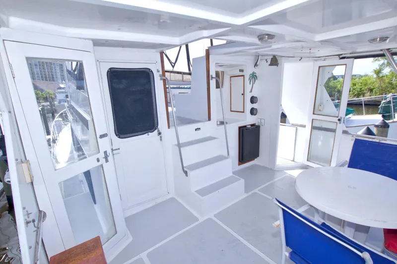 Slide: The Image of 1984 Present Yachts 42 Sundeck interior with white decor and blue seating. - 15