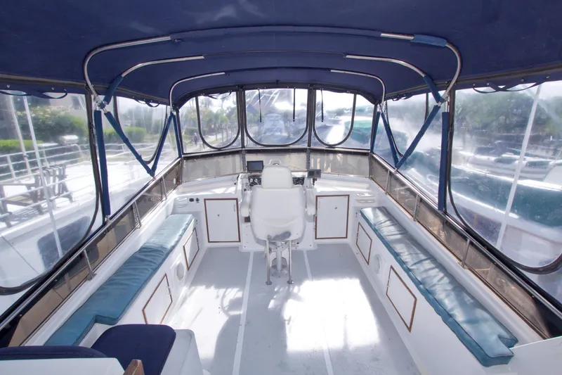 Slide: The Image of Interior view of 1984 Present Yachts 42 Sundeck with seating and helm station. - 16