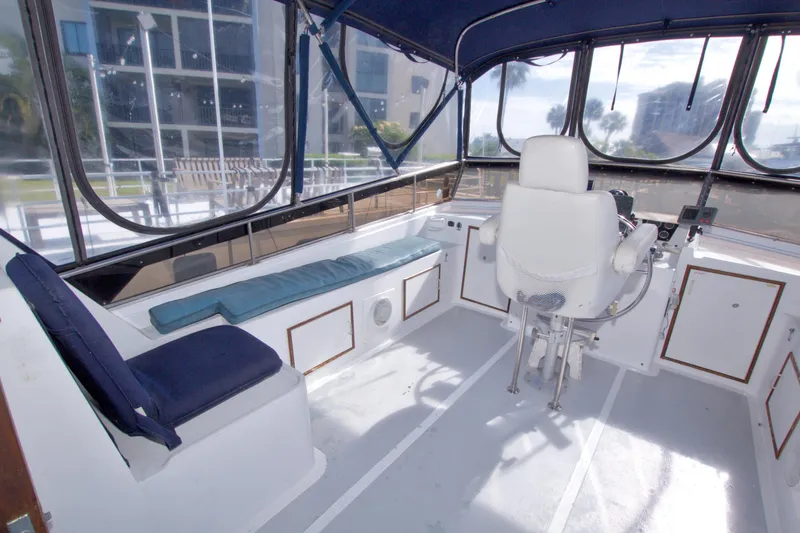 Slide: The Image of 1984 Present Yachts 42 Sundeck helm with seating, enclosed by clear panels. - 17