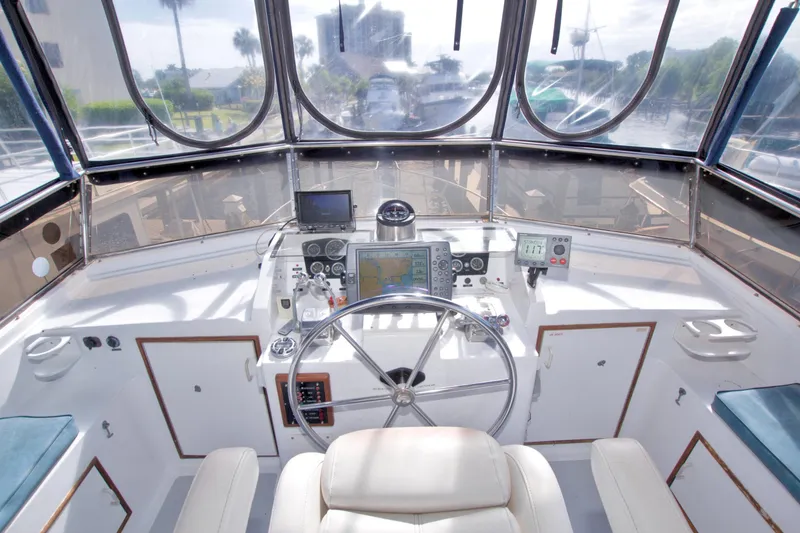 Slide: The Image of Helm of 1984 Present Yachts 42 Sundeck with navigation equipment and steering wheel. - 19
