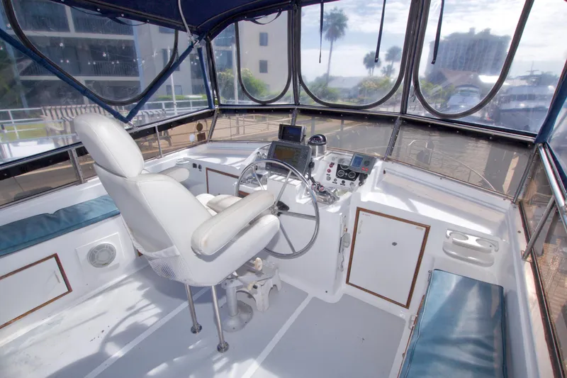 Slide: The Image of Cockpit of 1984 Present Yachts 42 Sundeck with steering wheel and navigation equipment. - 21