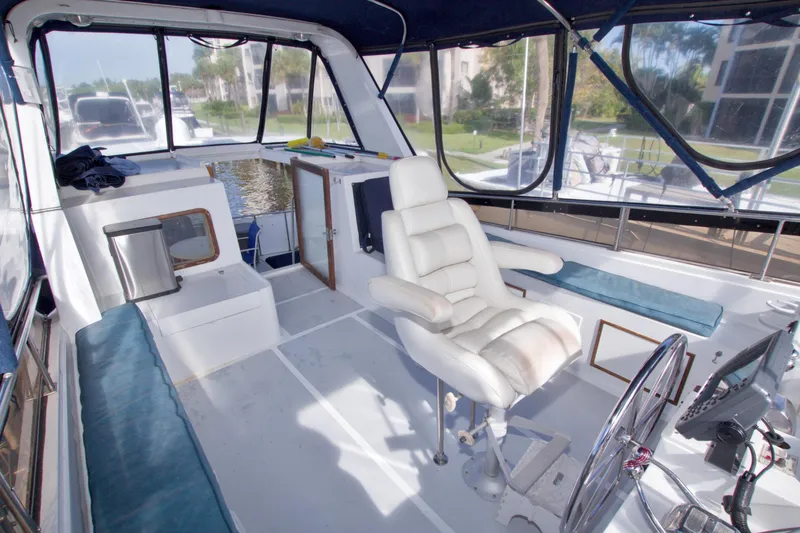 Slide: The Image of 1984 Present Yachts 42 Sundeck interior with helm, seating, and panoramic windows. - 23