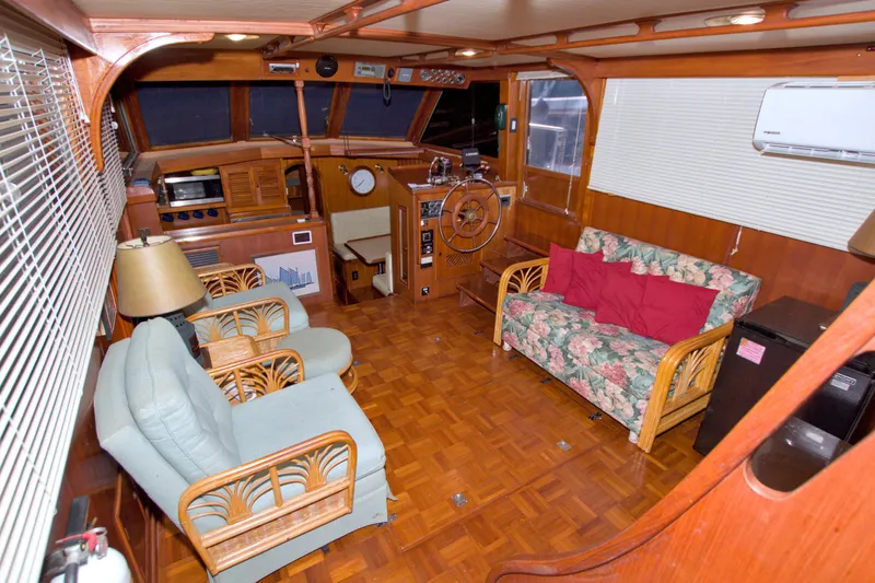 Slide: The Image of Interior of 1984 Present Yachts 42 Sundeck with wooden decor and cozy seating. - 28