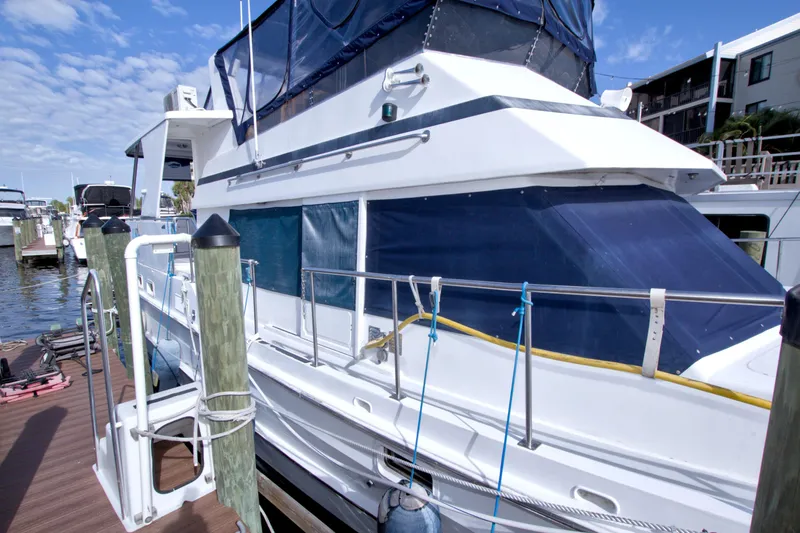 Slide: The Image of 1984 Present Yachts 42 Sundeck docked at marina under clear blue sky. - 3