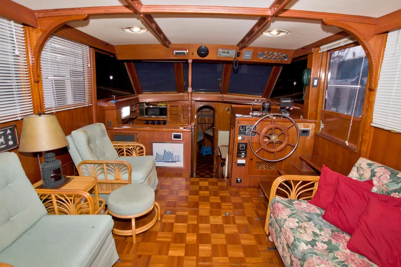 Slide: The Image of Interior of 1984 Present Yachts 42 Sundeck with wood paneling and nautical decor. - 30