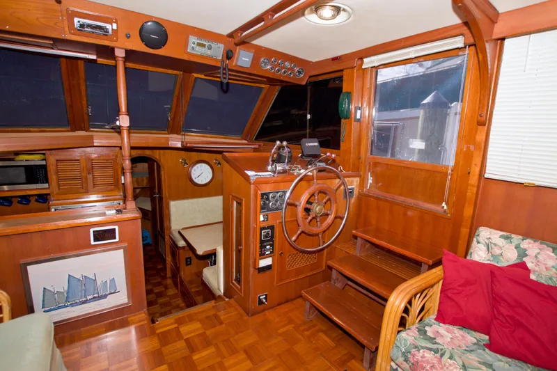 Slide: The Image of 1984 Present Yachts 42 Sundeck interior with wooden helm, seating, and nautical decor. - 32