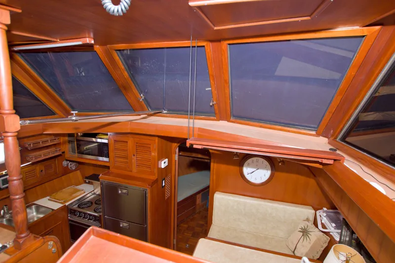 Slide: The Image of Interior of 1984 Present Yachts 42 Sundeck with wood finish and nautical decor. - 34
