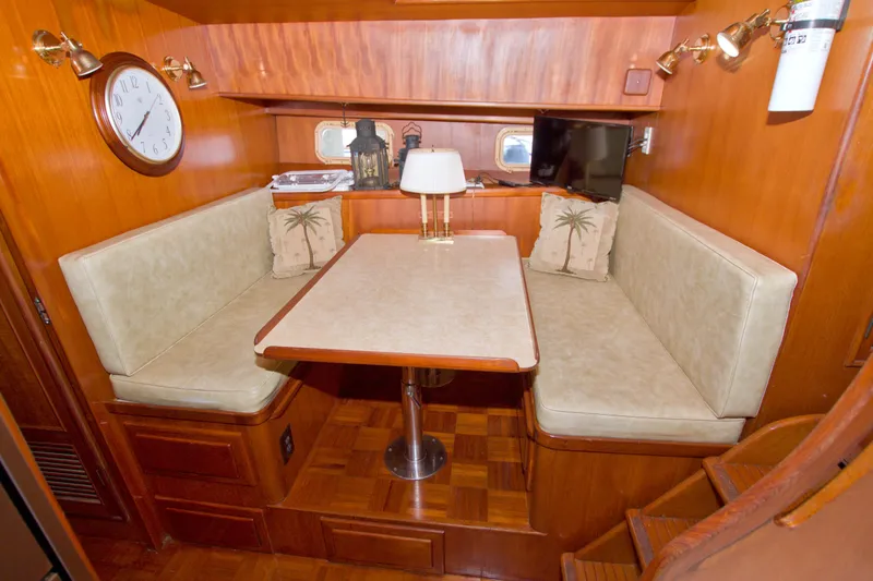 Slide: The Image of Cozy dining area in 1984 Present Yachts 42 Sundeck with wood paneling and cushioned seating. - 40