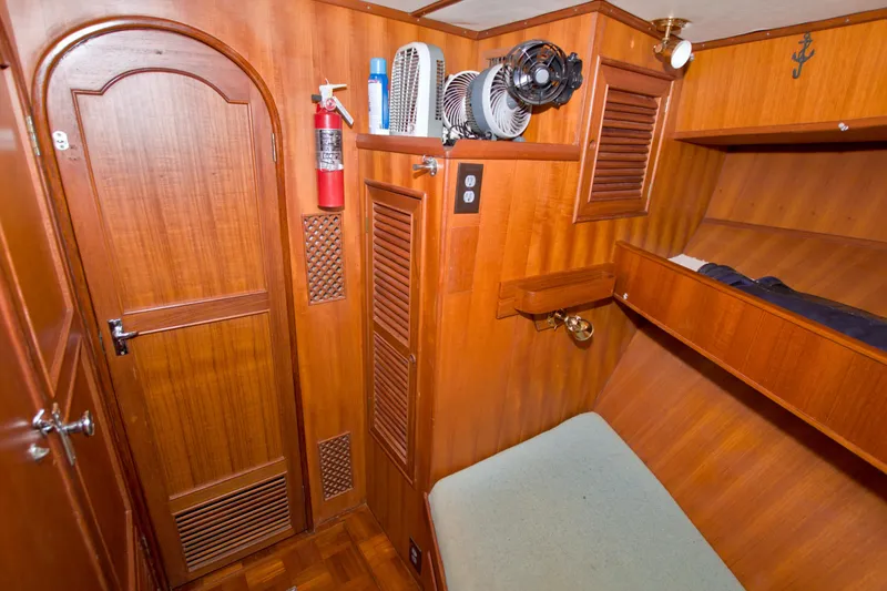 Slide: The Image of 1984 Present Yachts 42 Sundeck cabin interior with wooden paneling and bunk bed. - 42