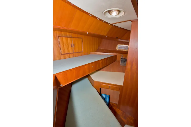 Slide: The Image of 1984 Present Yachts 42 Sundeck interior with wooden cabinetry and bunk beds. - 44