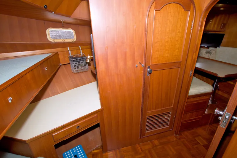 Slide: The Image of 1984 Present Yachts 42 Sundeck interior with wooden cabinetry and seating area. - 45