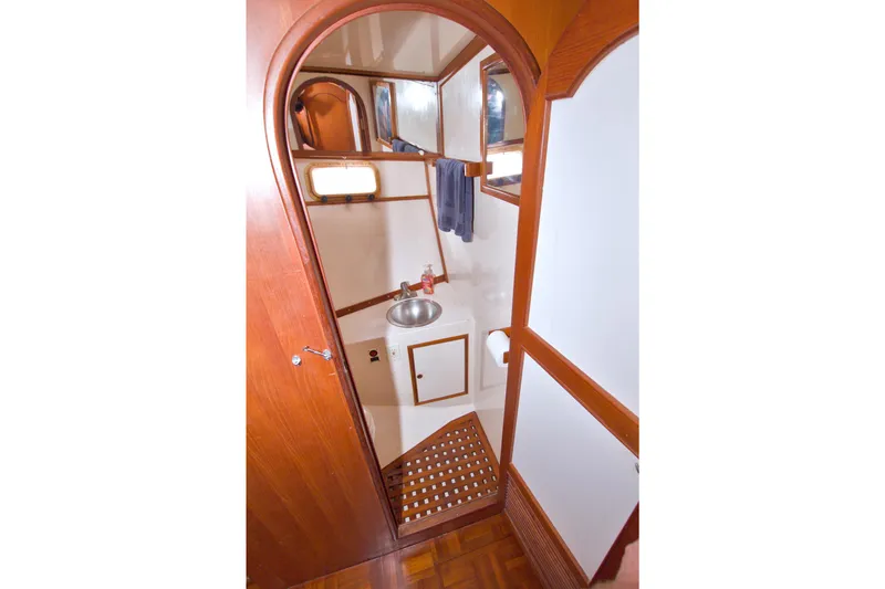 Slide: The Image of 1984 Present Yachts 42 Sundeck bathroom with wooden accents and stainless steel sink. - 46