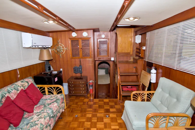 Slide: The Image of Interior of 1984 Present Yachts 42 Sundeck with wood paneling and cozy seating. - 49