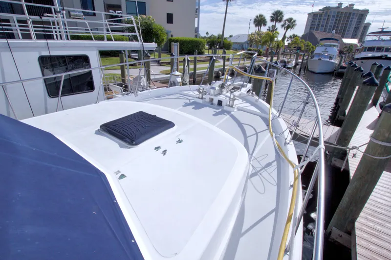 Slide: The Image of 1984 Present Yachts 42 Sundeck docked at marina, showcasing spacious deck and sleek design. - 5