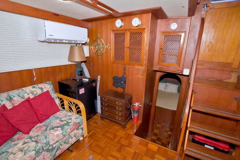 Slide: The Image of Cozy interior of 1984 Present Yachts 42 Sundeck with wood paneling and floral sofa. - 50