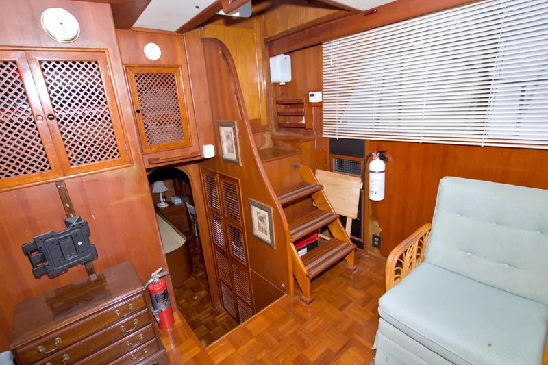 Slide: The Image of Interior of 1984 Present Yachts 42 Sundeck with wooden cabinetry and staircase. - 51