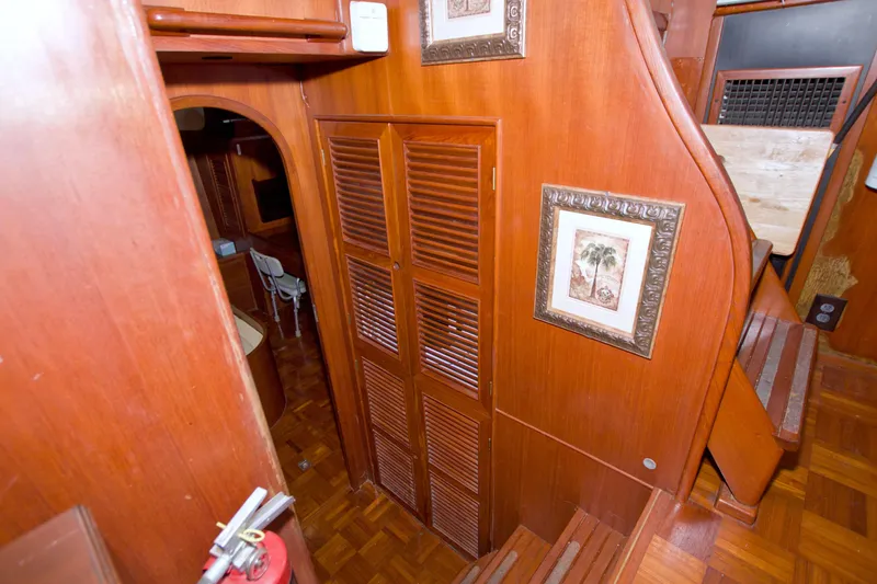 Slide: The Image of Interior of 1984 Present Yachts 42 Sundeck with wooden paneling and framed artwork. - 52