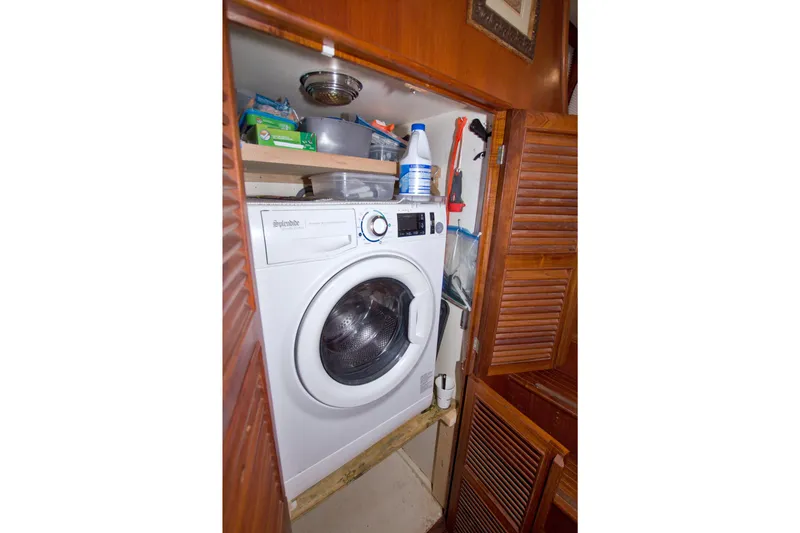 Slide: The Image of Laundry area with washing machine inside 1984 Present Yachts 42 Sundeck. - 53