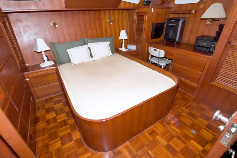 Slide: The Image of Luxurious 1984 Present Yachts 42 Sundeck cabin with wood paneling and cozy bed. - 54