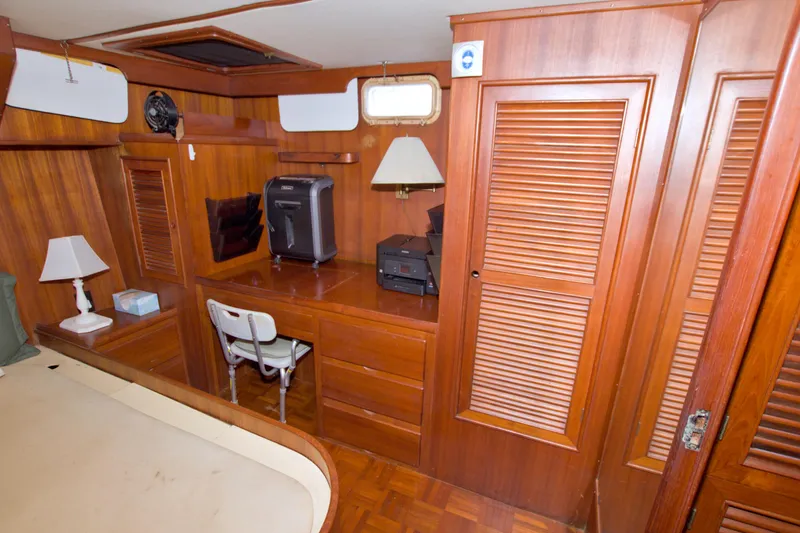 Slide: The Image of 1984 Present Yachts 42 Sundeck interior with wooden cabinetry and desk area. - 55