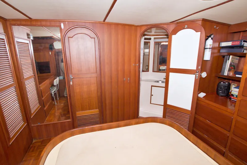 Slide: The Image of Interior of 1984 Present Yachts 42 Sundeck with wood paneling and built-in storage. - 56