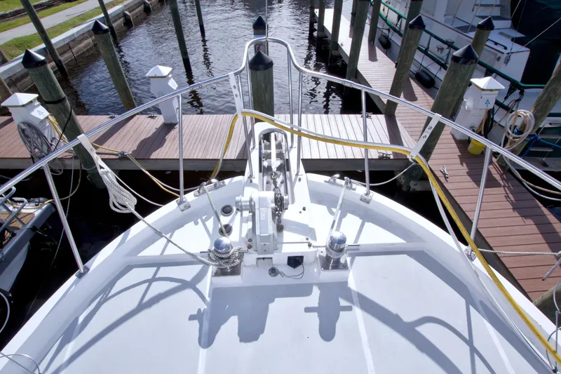 Slide: The Image of Bow view of 1984 Present Yachts 42 Sundeck docked at marina. - 6