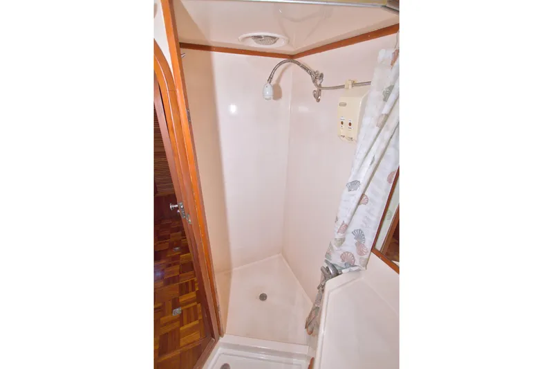 Slide: The Image of Shower area in 1984 Present Yachts 42 Sundeck with curtain and wooden accents. - 61