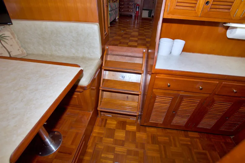 Slide: The Image of Interior of 1984 Present Yachts 42 Sundeck with wooden cabinetry and seating area. - 62