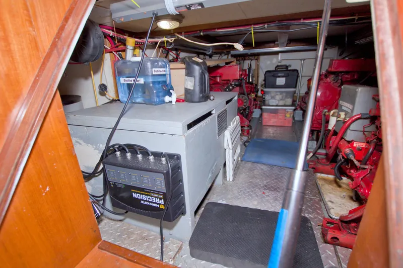 Slide: The Image of Engine room of 1984 Present Yachts 42 Sundeck, featuring equipment and storage. - 64