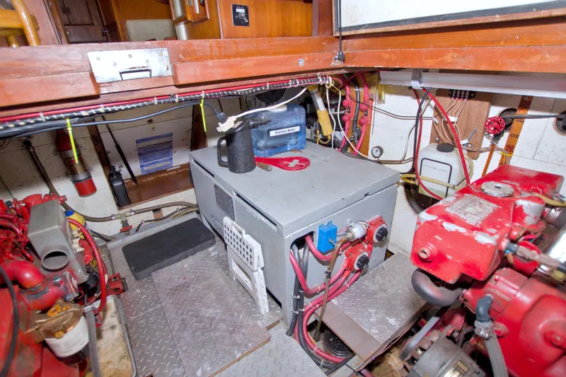 Slide: The Image of Engine room of 1984 Present Yachts 42 Sundeck, featuring mechanical components and wiring. - 69