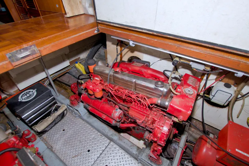 Slide: The Image of Engine room of 1984 Present Yachts 42 Sundeck, featuring a red marine engine. - 73